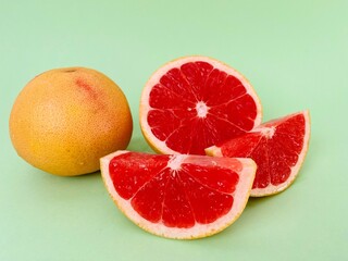 Fresh grapefruit fruit. Grapefruit isolated on green background. Grapefruit with clipping path.