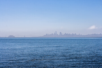 Naklejka premium View of San Francisco cityscape from Sausalito in Marin County, California. San Francisco cityline with boat crossing the bay.