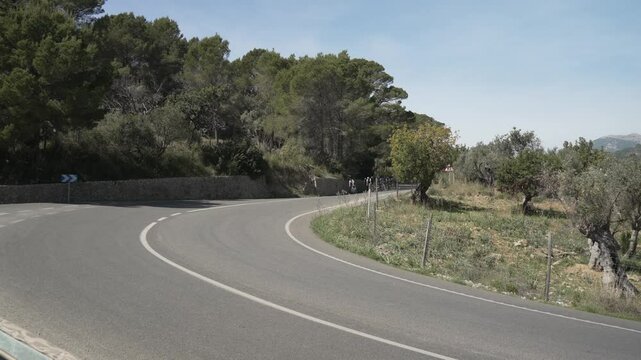 View of countryside and cyclists heading to hilltop town of Caimari, Majorca, Balearic Islands, Spain, Mediterranean, Europe