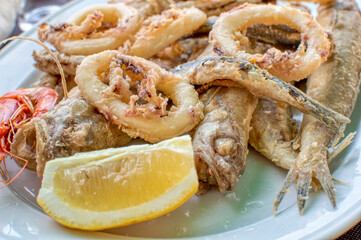 VIEW OF FRIED FISH WITH A SLICE OF LEMON