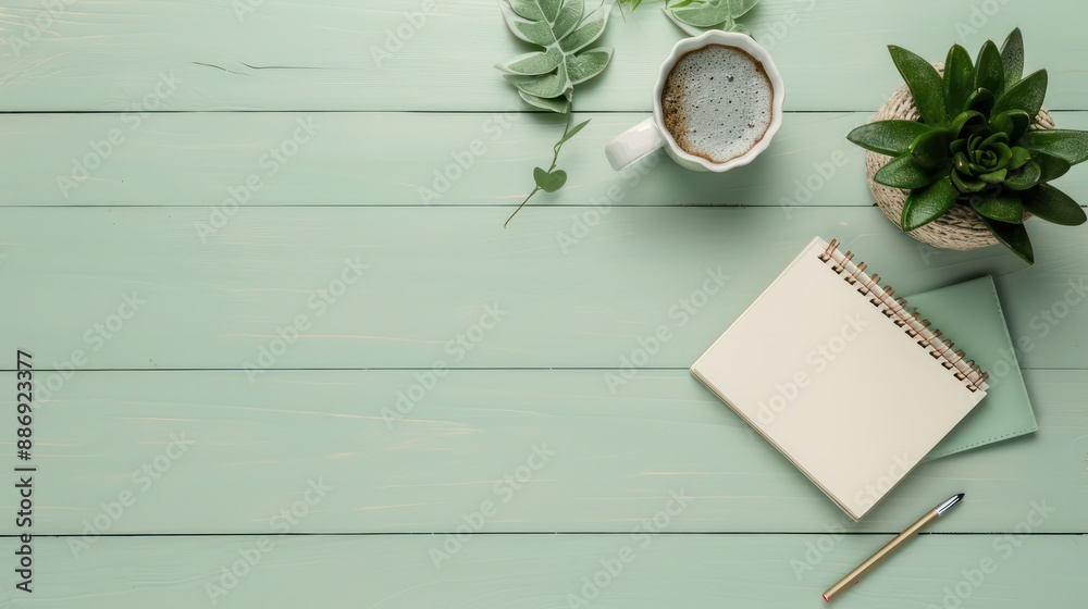 Poster a white notebook sits on a wooden table with a cup of coffee and a potted plant. concept of relaxati