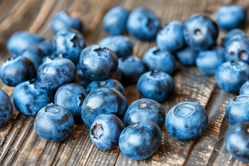 Close-up of fresh blueberries on rustic wooden table. Perfect for healthy eating, fruit, and nature themes.