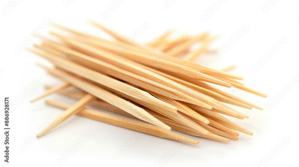 Poster a stack of wooden toothpicks arranged on a white surface, ideal for use as props or decorative eleme
