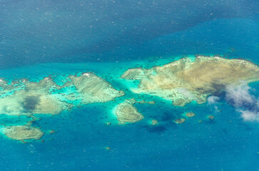 Spectacular aerial view on Great Barrier Reef on the way from Cairns to Lizard Island, Queensland, Australia. Great Barrier Reef¬†is the worlds largest coral reef system.
