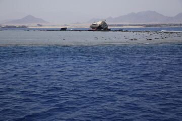 Shipwreck in shallow water on reef