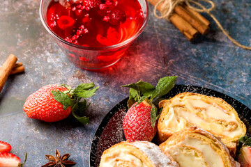 Sliced rolls with custard. The dessert is decorated with fresh strawberries.