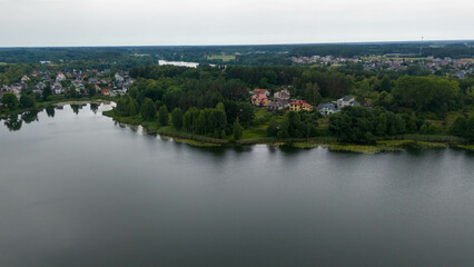 Fototapeta premium Drone photography of small town surrounded by lakes during summer day