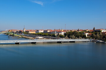 Obraz premium Movement of people and communication between cities. Travel landscape concept. A city stands on water under bridge. A bridge stands in water between lifestyle cities to facilitate communication 