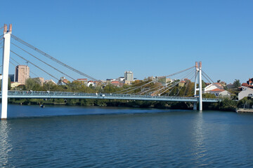 Obraz premium Movement of people and communication between cities. Travel landscape concept. A city stands on water under bridge. A bridge stands in water between cities to facilitate lifestyle communication 