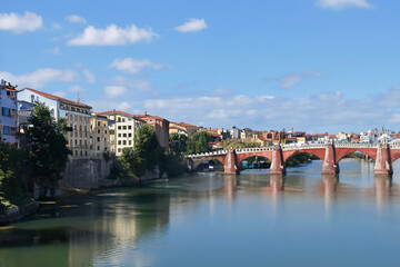 Fototapeta premium Movement of people and communication between cities. Travel landscape concept. A city stands on water under bridge. A bridge stands in water between cities to facilitate communication lifestyle
