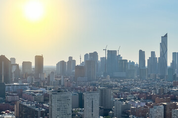 Rays of sun over megapolis on a foggy morning. urban sky sunrise concept. city illuminated by sun in the early morning. a city illuminated by the rays of the sun in lifestyle the early morning.