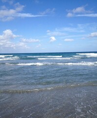 sea and sky 
beach 
waves
blue sky
clouds
water
