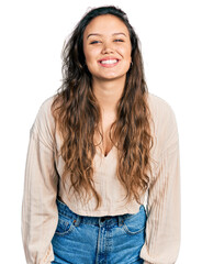 Young hispanic girl wearing casual clothes with a happy and cool smile on face. lucky person.