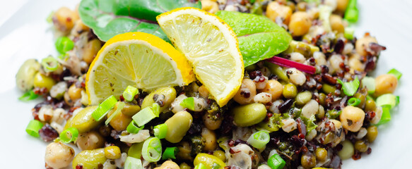 A colorful salad with chickpeas, quinoa, and vegetables