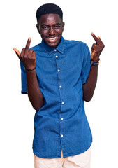 Young african american man wearing casual clothes showing middle finger doing fuck you bad...