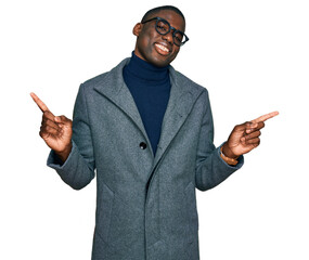 Young african american man wearing business clothes and glasses smiling confident pointing with fingers to different directions. copy space for advertisement