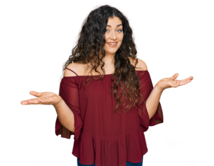 Young hispanic girl wearing casual clothes clueless and confused expression with arms and hands raised. doubt concept.