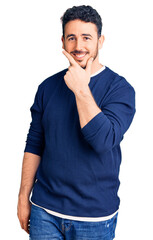 Young hispanic man wearing casual clothes looking confident at the camera smiling with crossed arms and hand raised on chin. thinking positive.