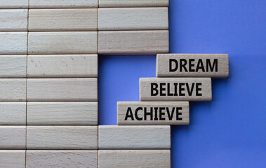 Obraz premium Dream Believe Achieve symbol. Concept words Dream Believe Achieve on wooden blocks. Beautiful purple background. Business and Dream Believe Achieve concept. Copy space