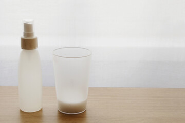 Hand sanitizer, gel-alcohol mixture with gelatin in a clear plastic bottle with pump.