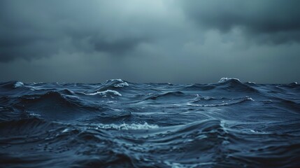 Noir style photograph of moody waves in shades of slate and charcoal crashing under an overcast sky of deep indigo and steel gray.