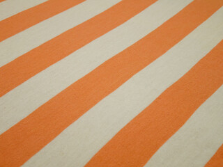 Fototapeta premium White thin fabric with wide orange stripes, background 