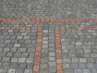 Fototapeta premium Traditional pavement with grey and red cobblestones in the historic centre of Geneva. Switzerland.