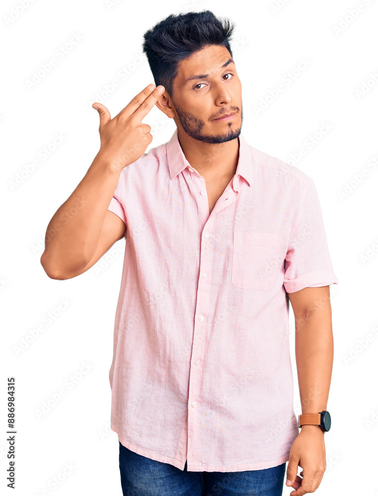 Wall mural handsome latin american young man wearing casual summer shirt shooting and killing oneself pointing 