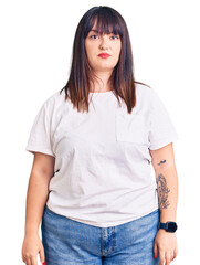Young plus size woman wearing casual clothes relaxed with serious expression on face. simple and...