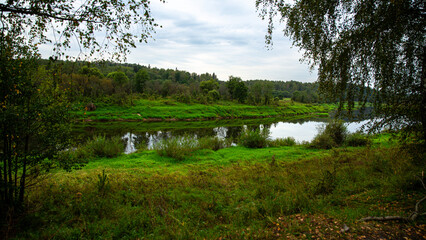 A picturesque riverside scene featuring abundant greenery and tranquil waters in a serene setting