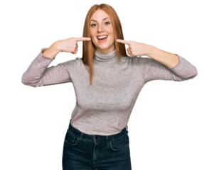 Young irish woman wearing casual clothes smiling cheerful showing and pointing with fingers teeth and mouth. dental health concept.