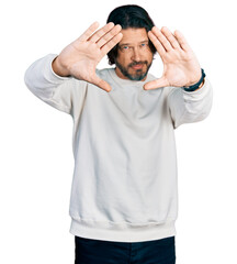 Middle age caucasian man wearing casual clothes doing frame using hands palms and fingers, camera perspective