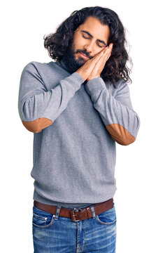 Young arab man wearing casual clothes sleeping tired dreaming and posing with hands together while smiling with closed eyes.