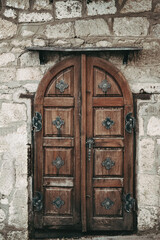 Elegant old double door entrance of brick vintage building in Europe. Vintage wooden doorway of ancient stone house. Simple brown shabby wood door. Architecture in Hungary.