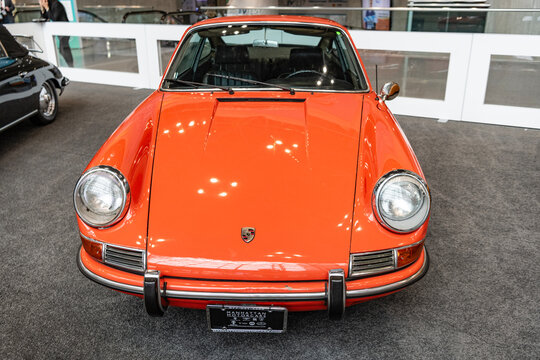 New York City, USA - March 27, 2024: 1967 Porsche 912 retro vehicle orange color at New York International Auto Show in Manhattan, front view