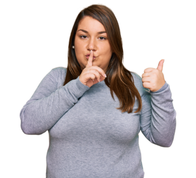Beautiful brunette plus size woman wearing casual clothes asking to be quiet with finger on lips pointing with hand to the side. silence and secret concept.