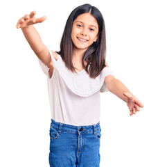 Beautiful child girl wearing casual clothes looking at the camera smiling with open arms for hug....