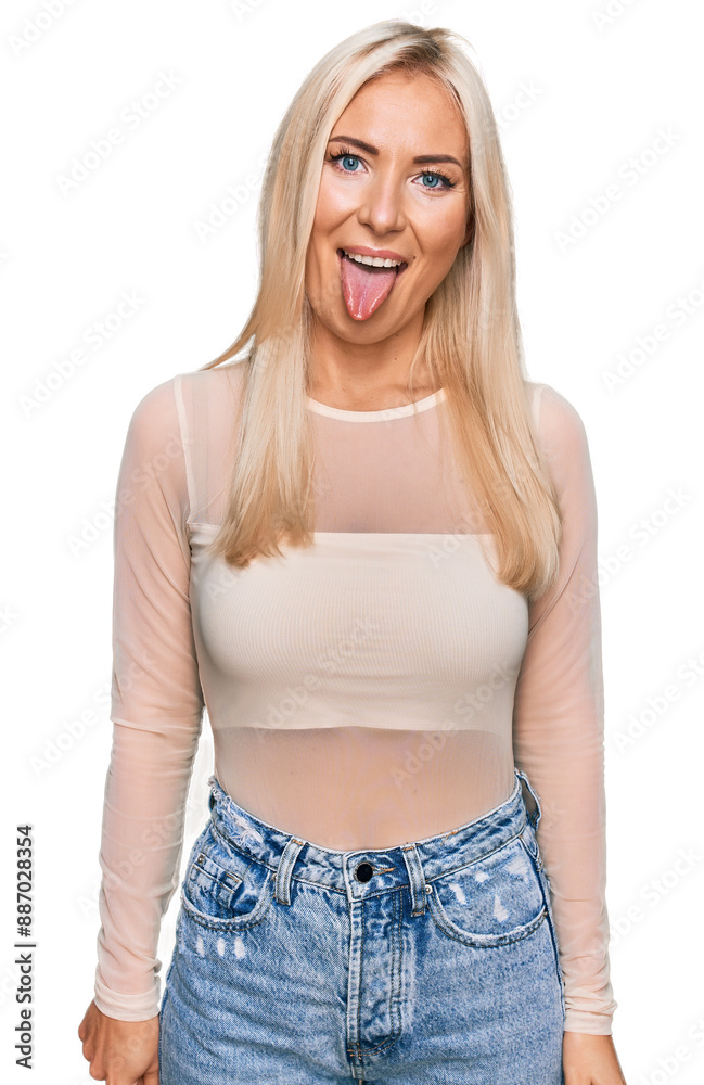 Canvas Prints young blonde woman wearing casual clothes sticking tongue out happy with funny expression. emotion c