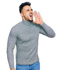 Young arab man wearing casual clothes shouting and screaming loud to side with hand on mouth....