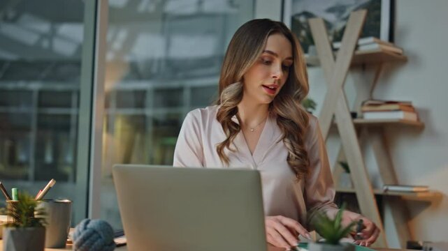 Market manager working night in agency. Woman opening laptop lid in evening