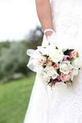 Bride holding bouquet, cropped