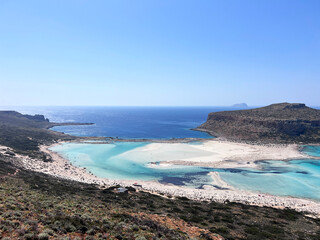 Balos lagoon on Crete island, Greece. Tourists relax and bath in crystal clear water of Balos beach. no effects