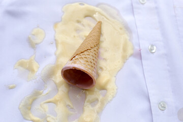 Iice cream with waffle cone on a white shirt, dirty stain