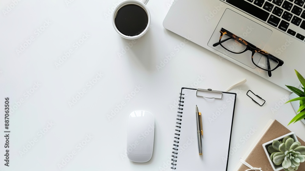 Wall mural top view of office essentials including a notepad laptop coffee cup mouse pad and mobile phone with 