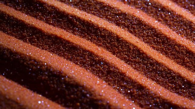 Small bright orange crystals of potassium dichromate, close up, abstract colorful background