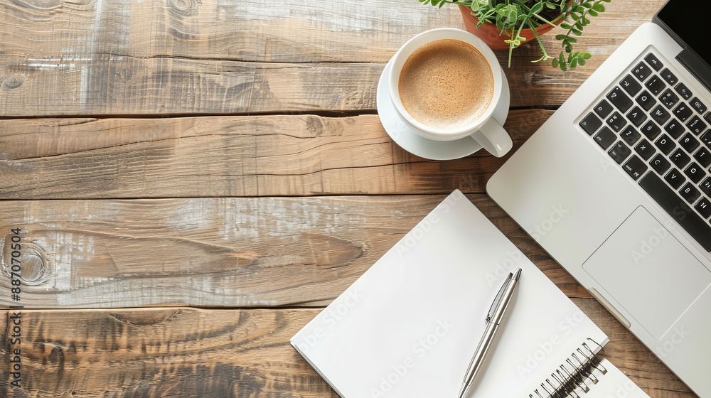 Wall mural work from home concept office desk setup with a laptop blank notepad coffee cup and pen on a wooden 