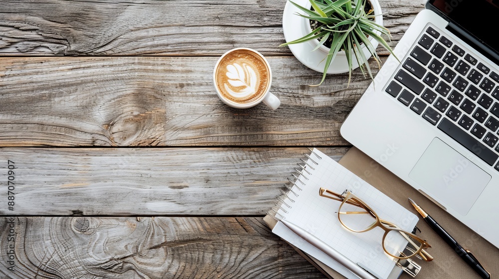 Wall mural work from home concept office desk setup with a laptop blank notepad coffee cup and pen on a wooden 