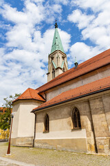 Fototapeta premium City of Celje in Slovenia, beautiful village decorated with flowers, traditional buildings with towers and castle, interesting tourist stop. Artistic graffiti. Main street with church and gold statue