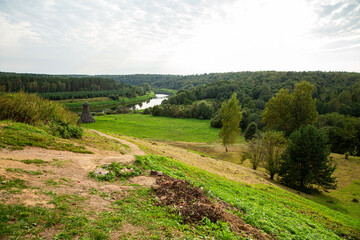 Scenic River Valley Landscape with Abundant Greenery and Trees beneath a Cloudy Sky