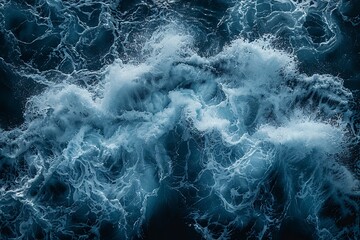 Obraz premium An impressive aerial top-view photograph of ocean water with white waves splashing in the deep sea.